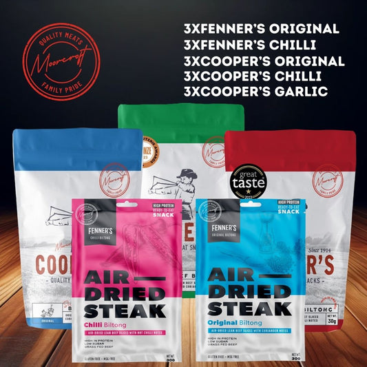 A collection of air-dried meat snacks from Fenner's and Cooper's is displayed. There are three varieties of Fenner's Biltong: Original, Chilli, and a packet of Cooper's Biltong in Original, Chilli, and Garlic flavours. Each packet has a distinct colour at the top—blue, pink, and green—indicating different flavours, all bearing the 'Great Taste 2023' award seal.